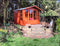 Traditional varnished double-doored summer house/shed with doors closed
